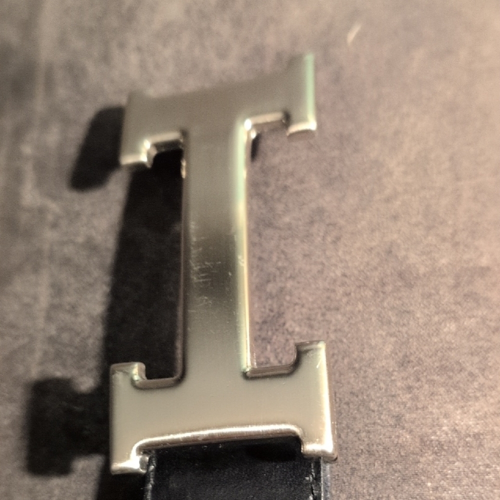 Hermes Silver Belt Buckle On A Black Leather Belt